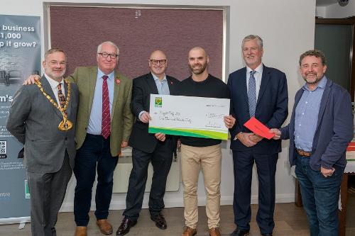 James Charalambous receives his cheque from the Dacorum's Den panel