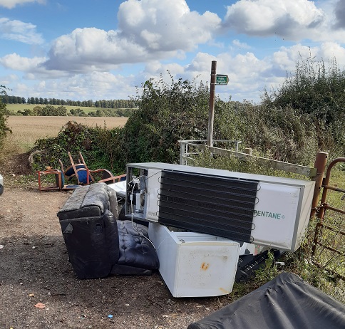 White goods and furniture fly-tipped in rural lane near Flamstead