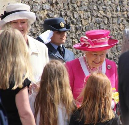 The Queen accepts flowers from local children